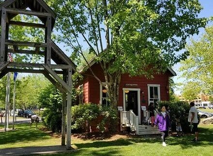 Photo of te Bothell Historical Museum School, an old, red, single-room schoolhouse.